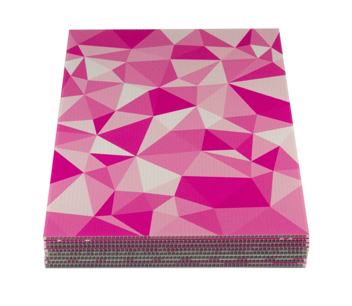  A stack of Correx® boards displayed in Carrick brand colours, showcasing the lightweight fluted board material used for outdoor signage, promotional displays, and Correx® board printing applications.